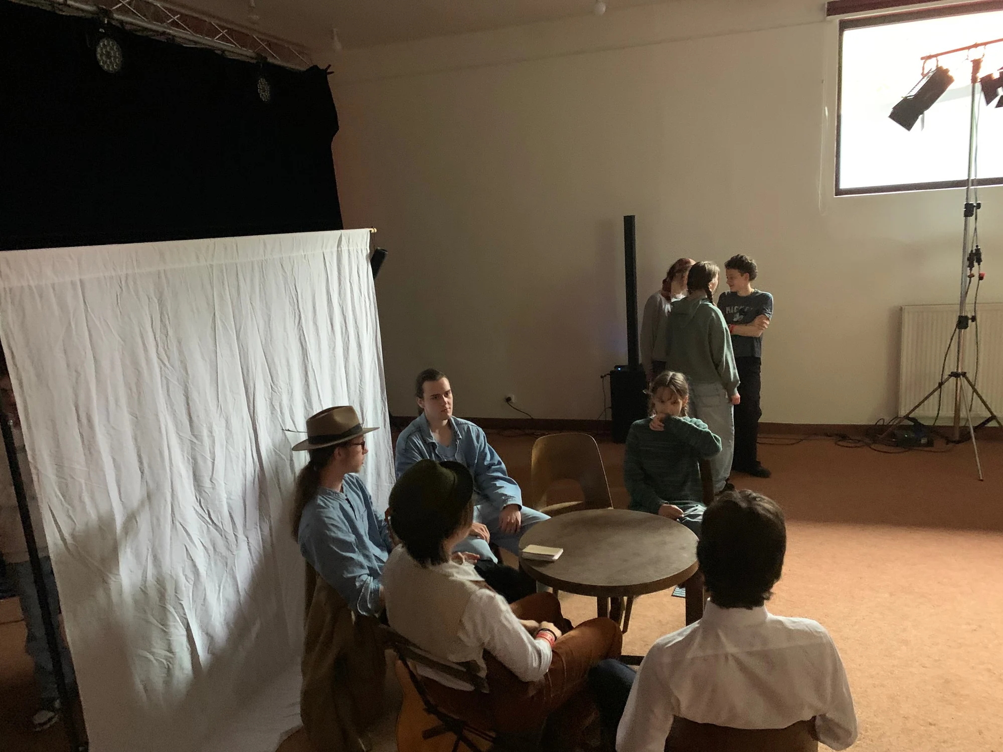 Young actors rehearsing the story of Jan Jelínek around a table