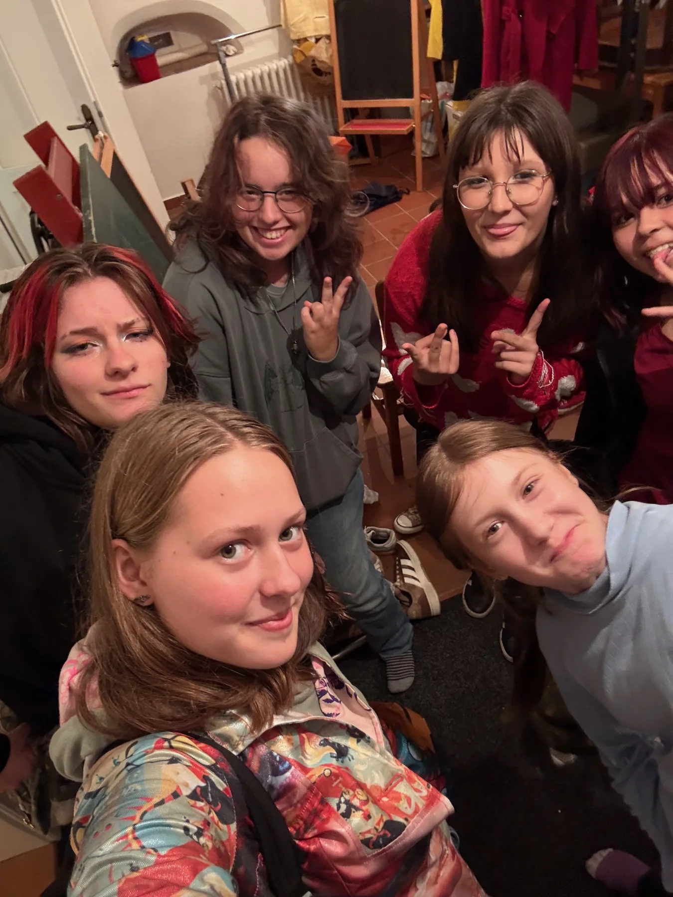 A group of friends taking a cheerful selfie at a Scout meeting
