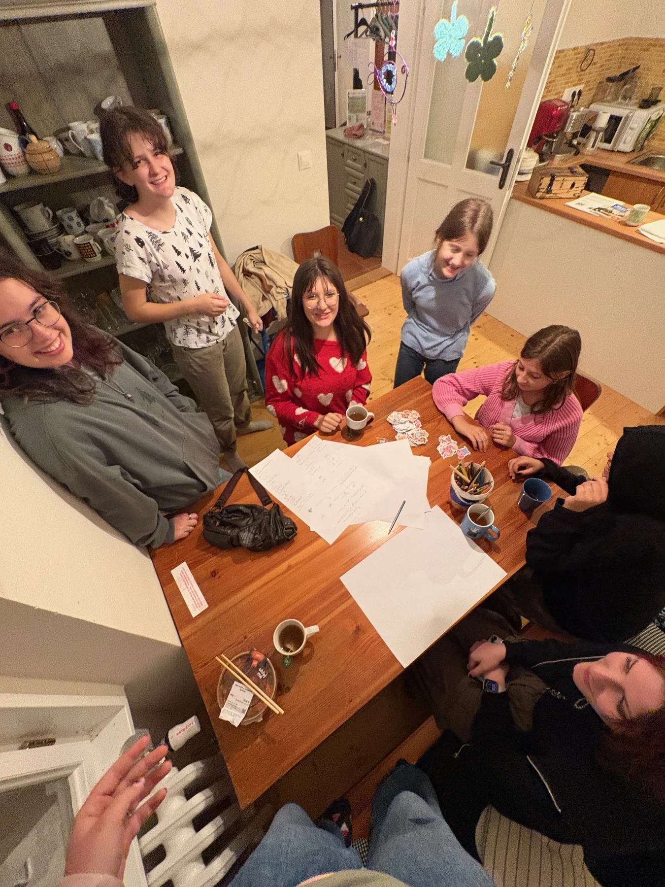 Friends drawing and creating together around a table