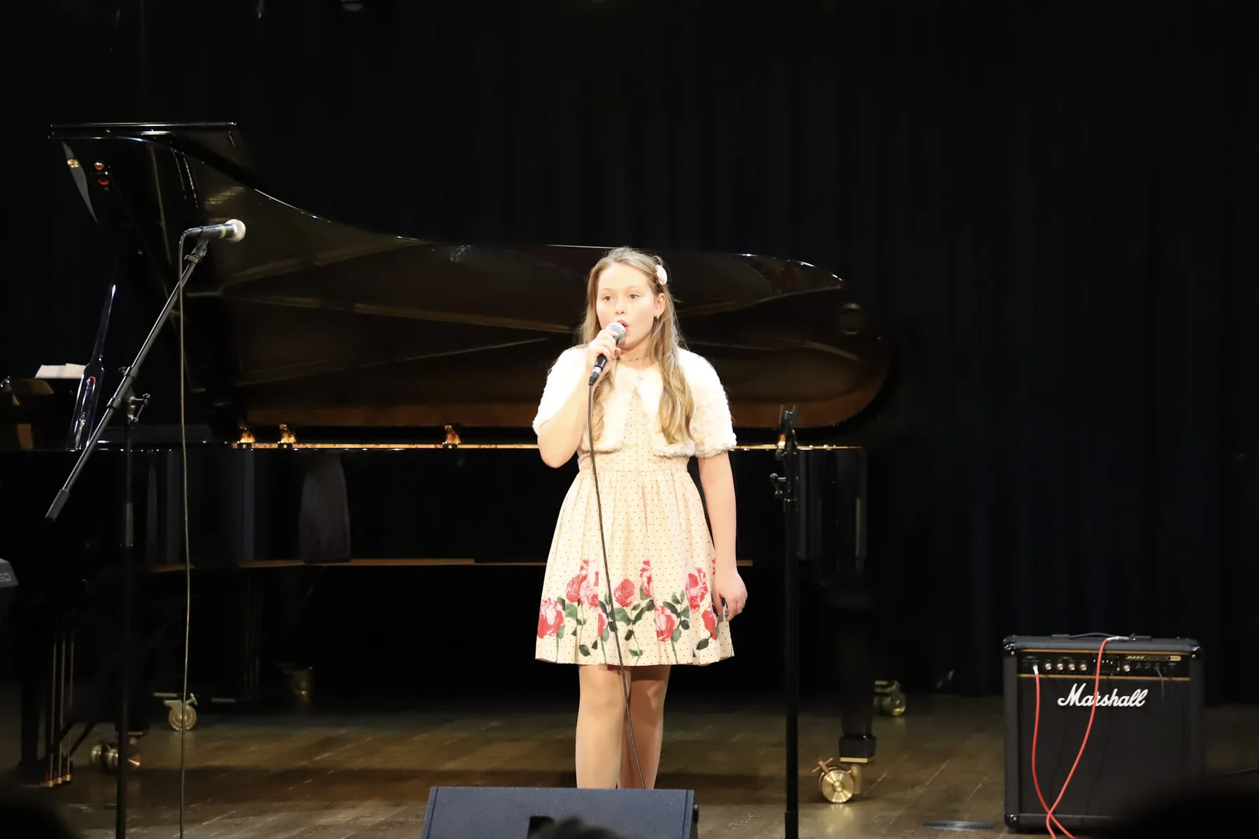 Magdaléna singing solo on stage